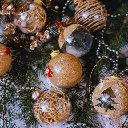 Decorative Christmas ornaments on a tree with gold, brown, and clear glass balls.